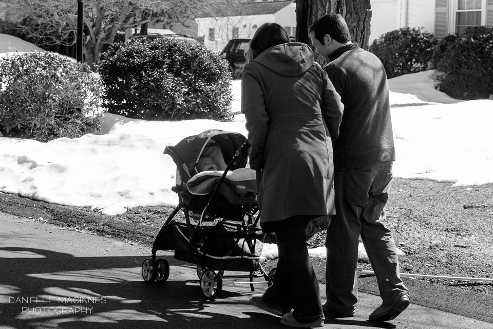 mom and dad pushing baby in stroller