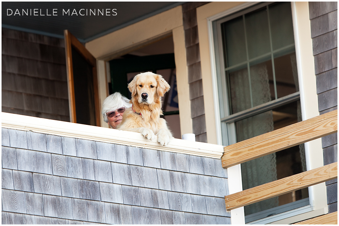 woman and dog looking over porch railing