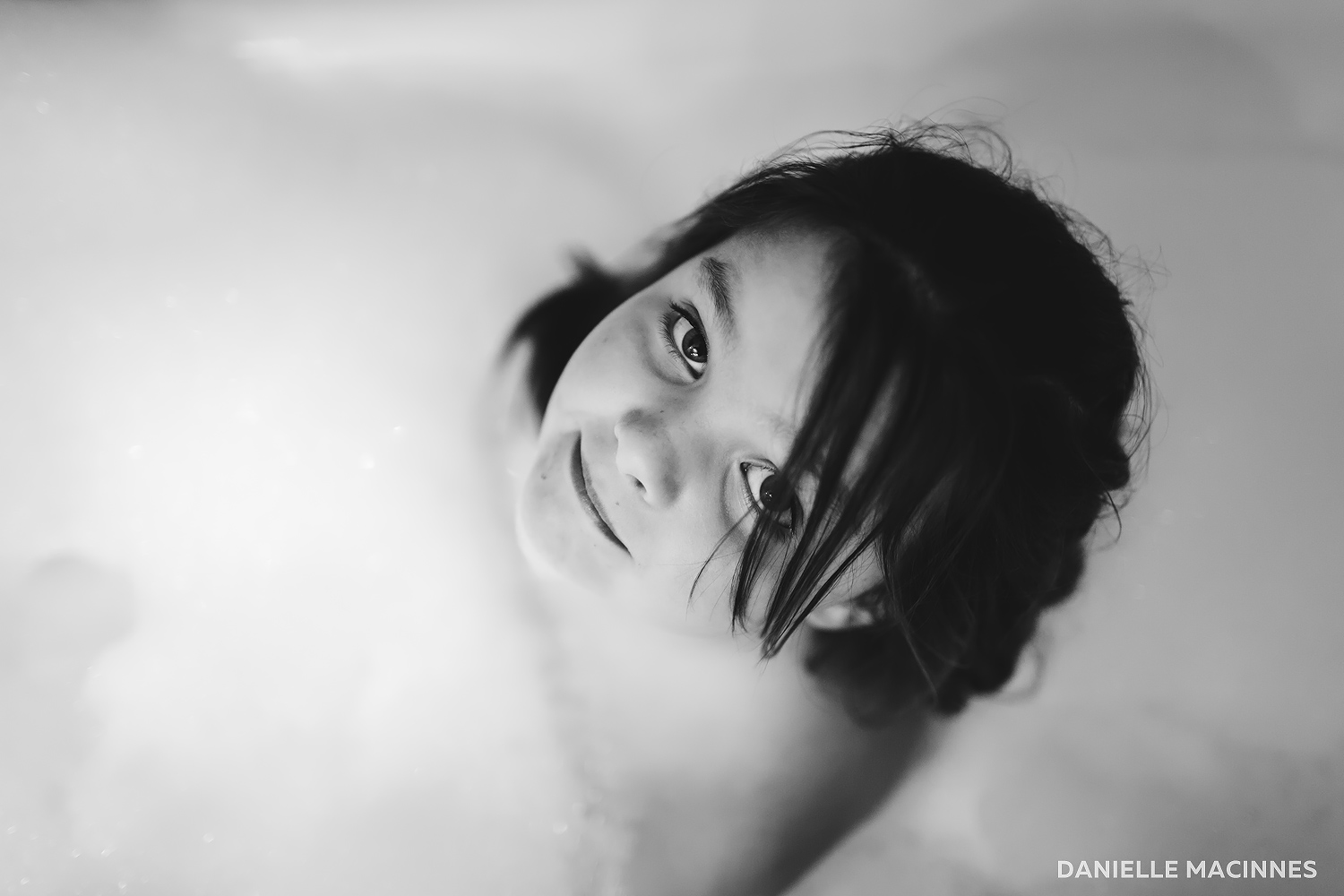 girl in bathtub looking up