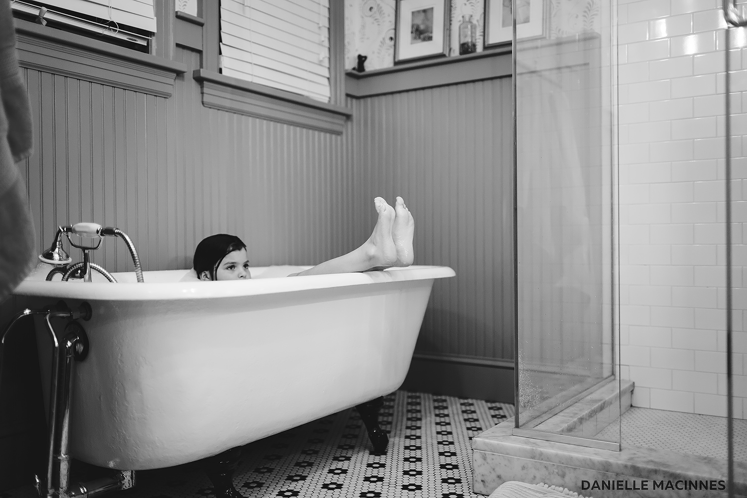 girl with legs sticking out of bathtub