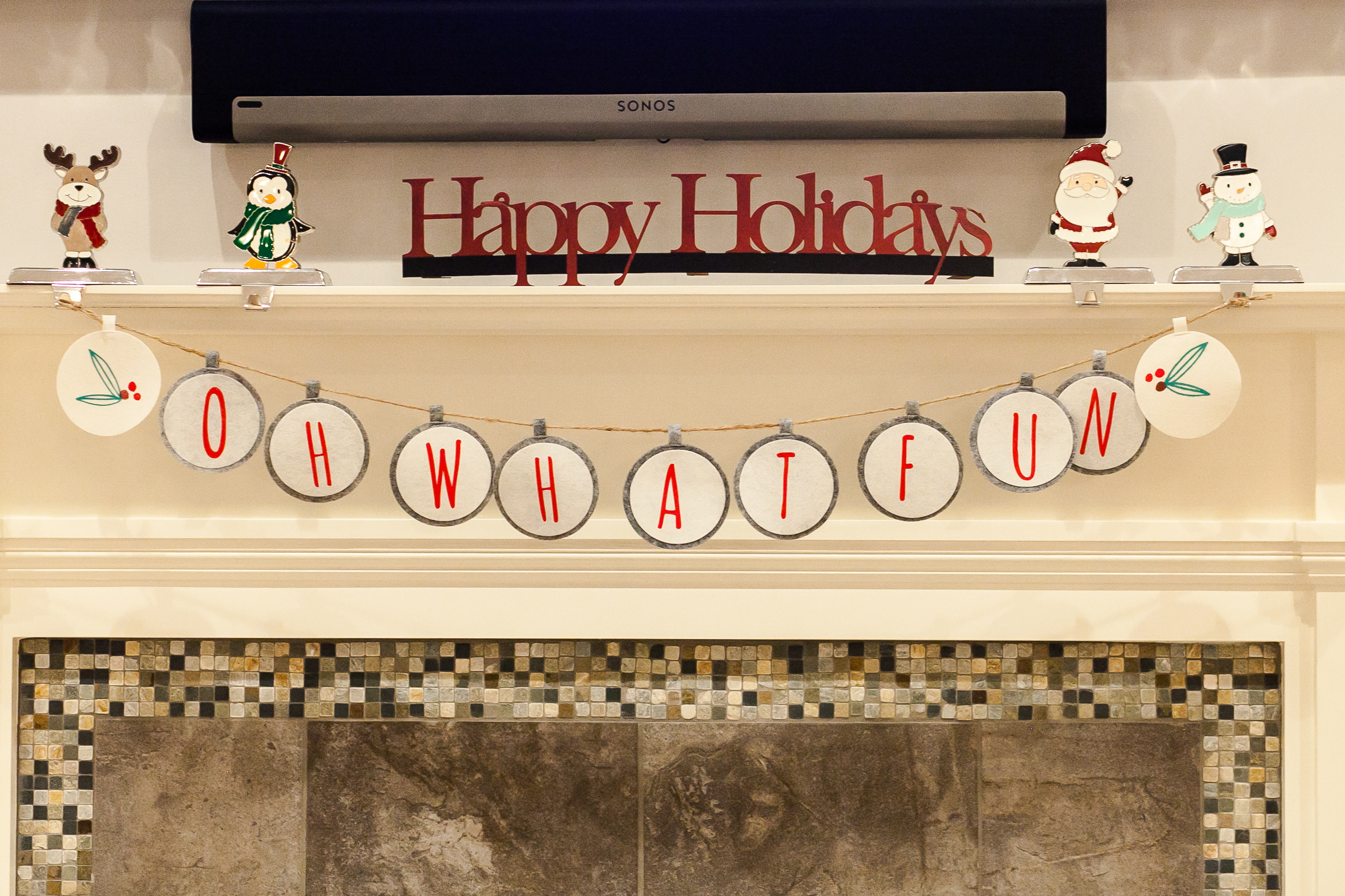 mantle decorated with Happy Holidays