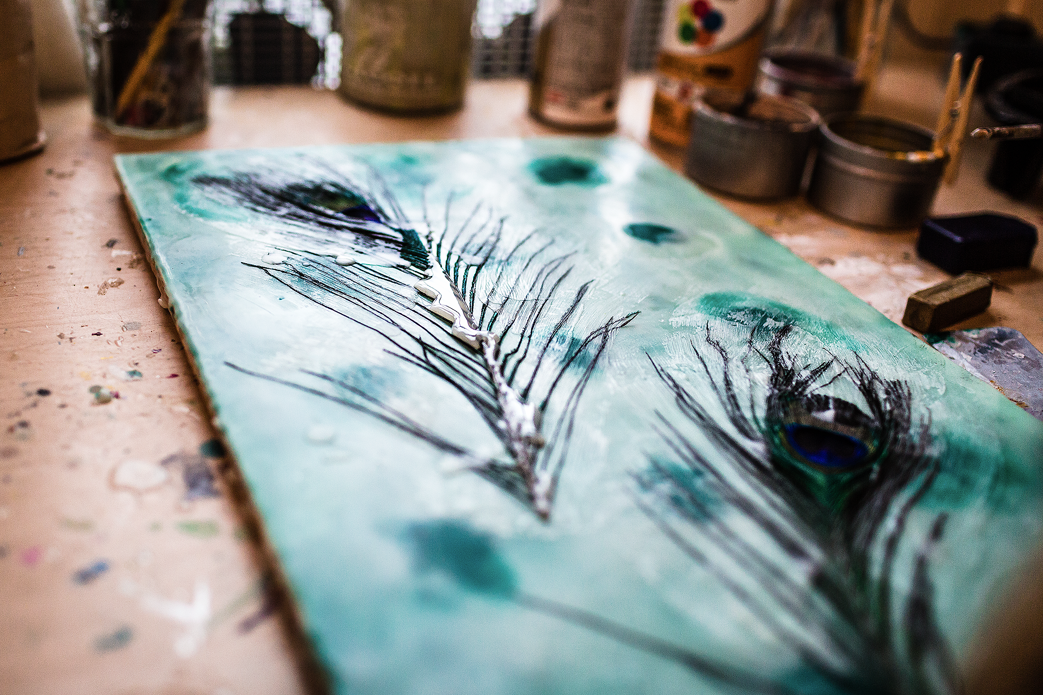 peacock feathers with melted wax on canvas