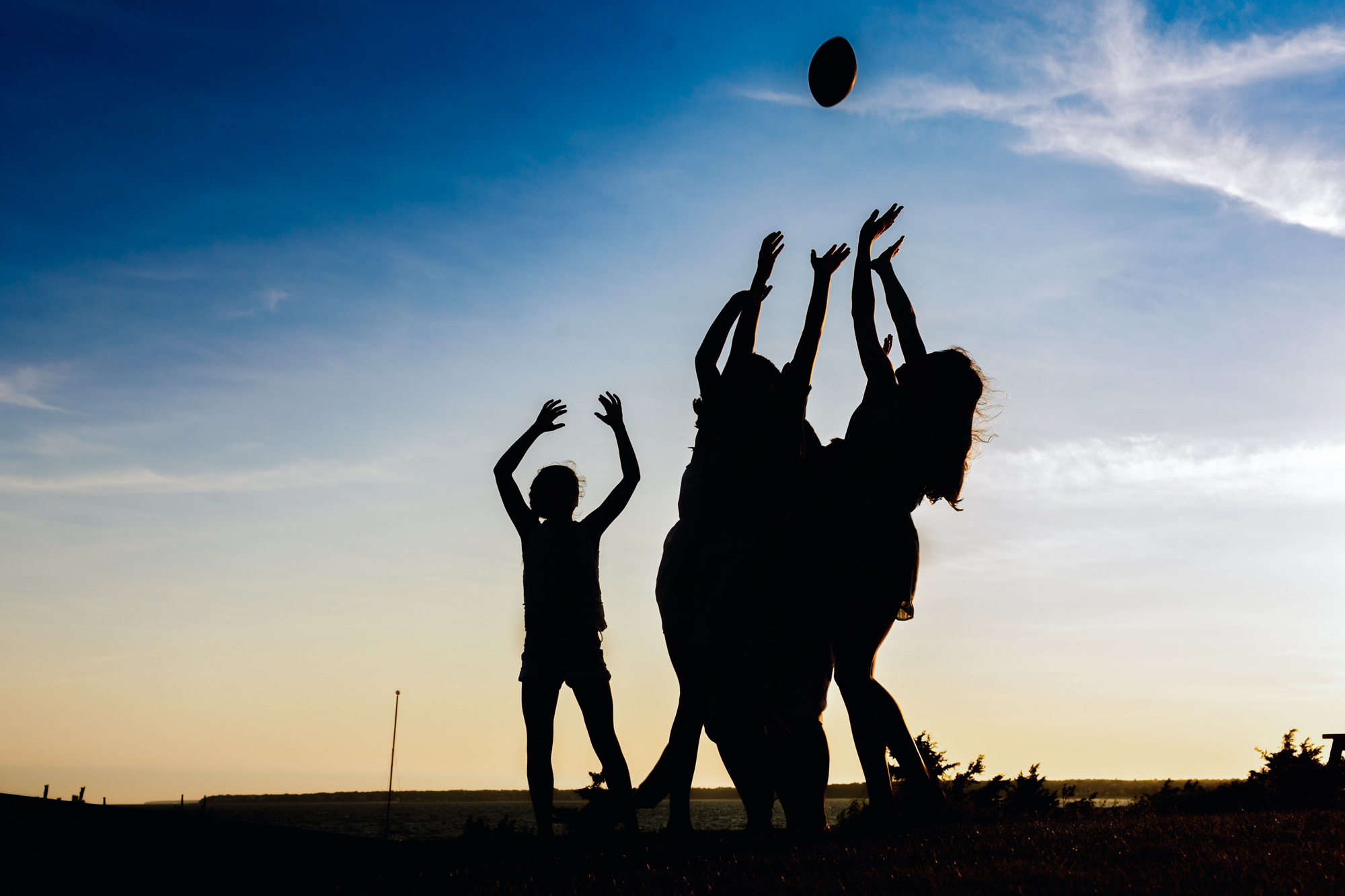 silhouette of kids jumping for football