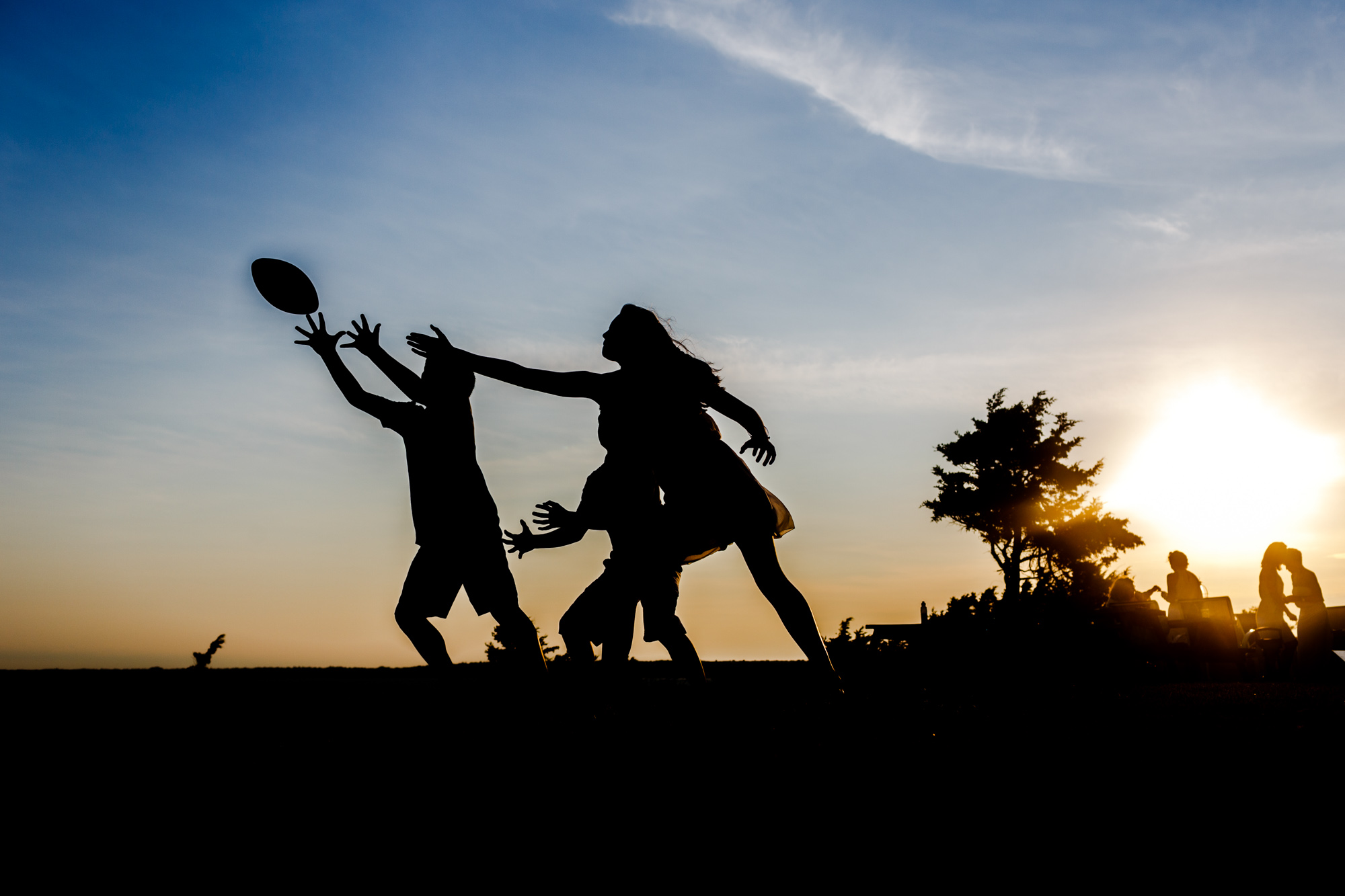 silhouette of kids reaching for football
