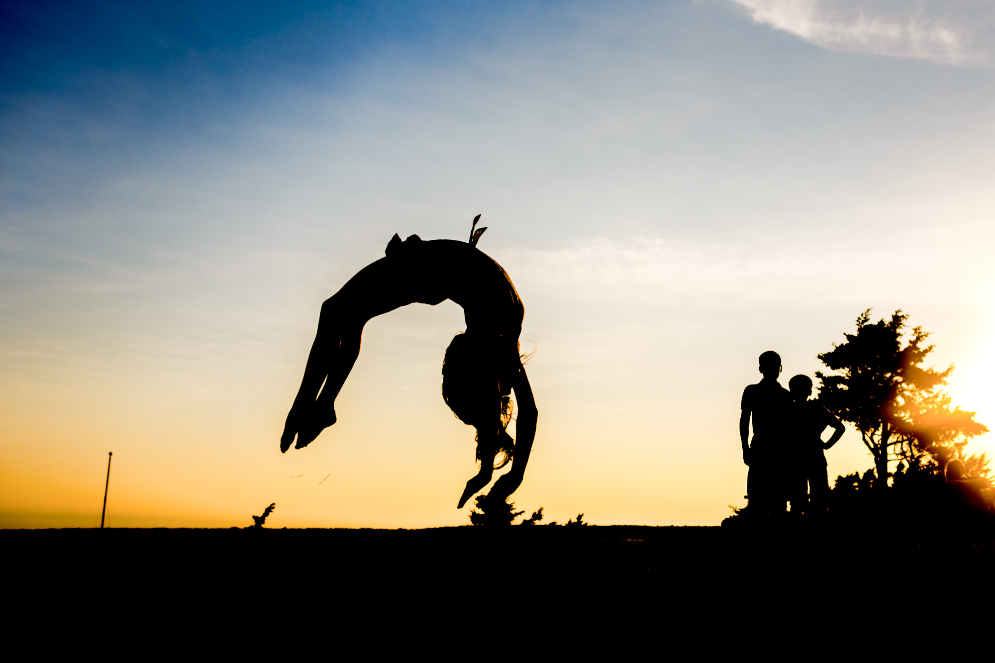 silhouette of girl doing back flip