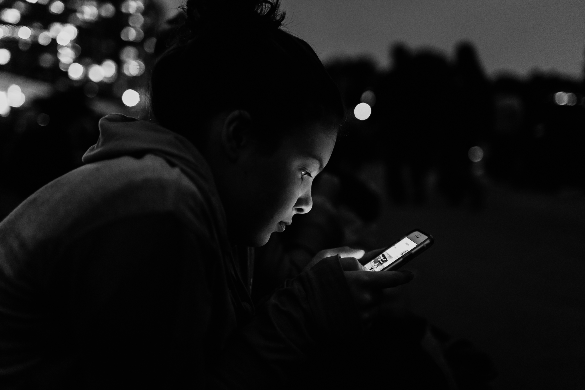 published photo of a girl holding a cell phone lighting up her face