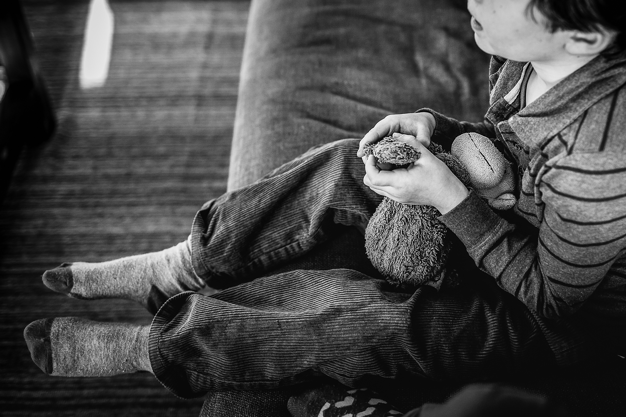 little boy's hands holding stuffed animal monkey