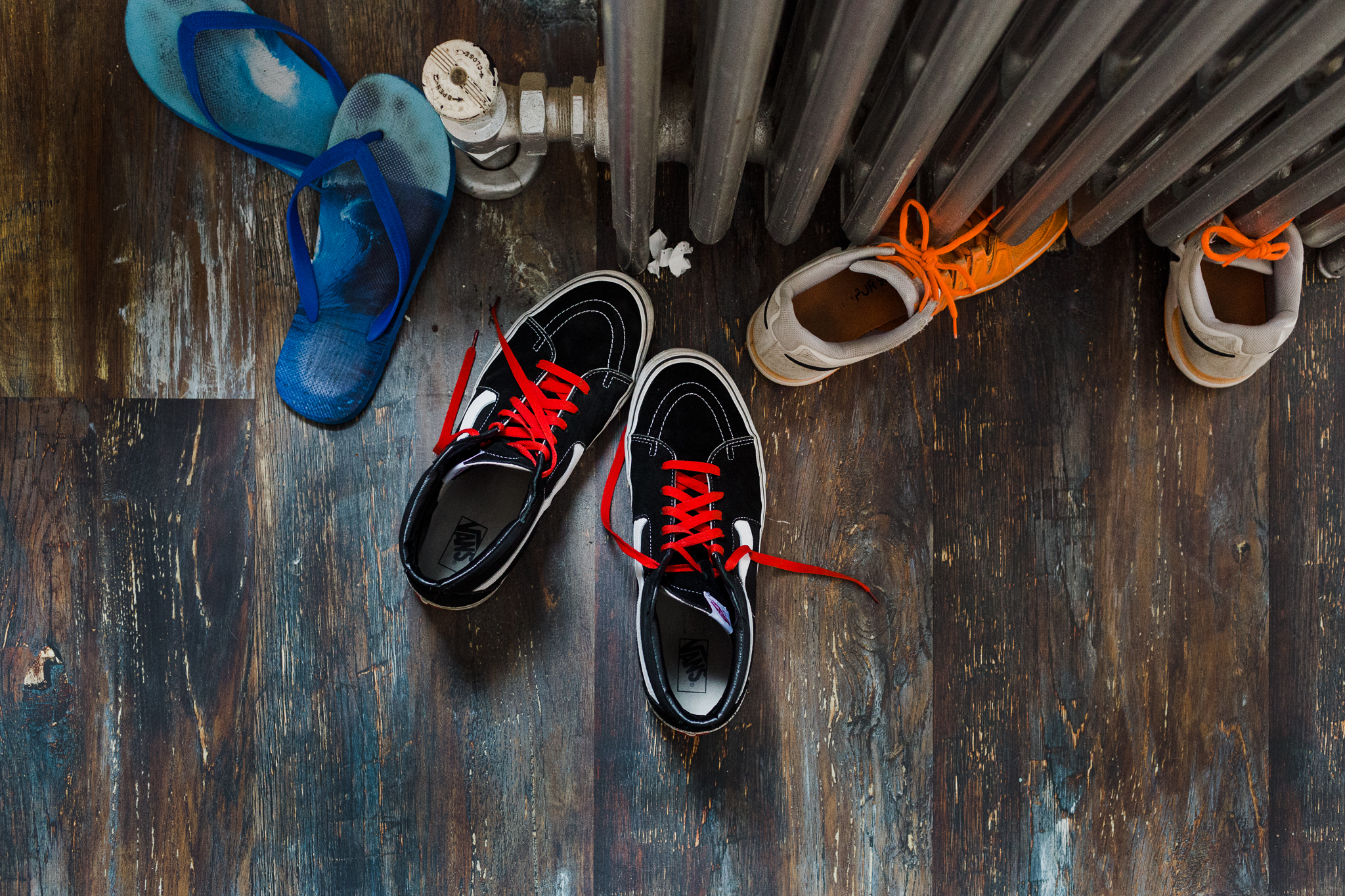 3 pairs of sneakers on the floor